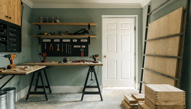 Small garage woodworking shop organized with compact tool zones and staged materials